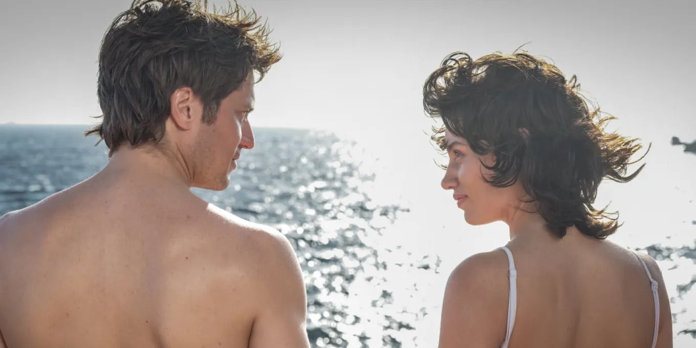 Lucas Bravo and Lea Luce Busato stand romantically by the sea in Freedom