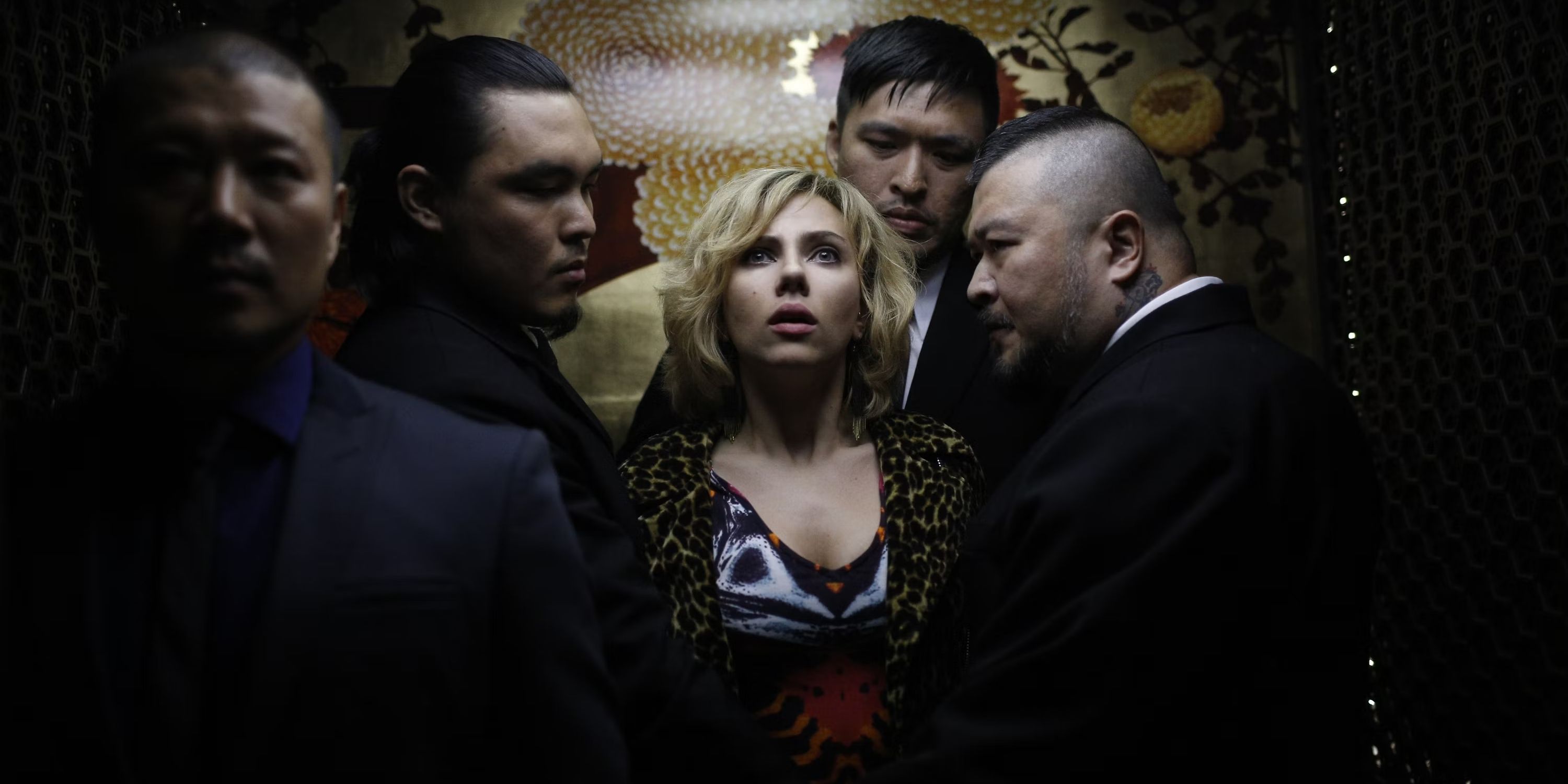 Lucy in an elevator with other men in Lucy