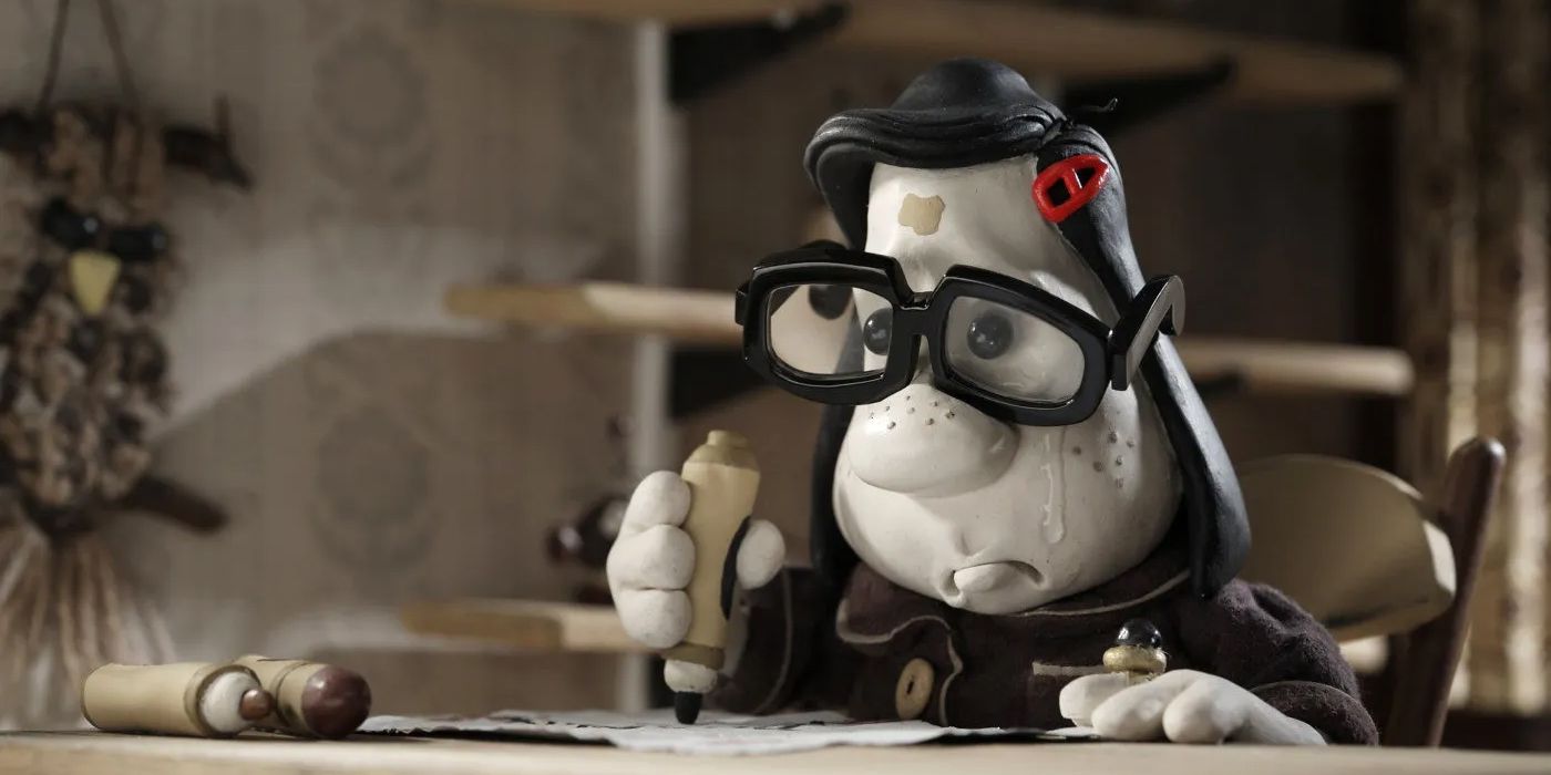 A young girl wearing glasses and writing a letter while crying in the claymation movie Mary and Max