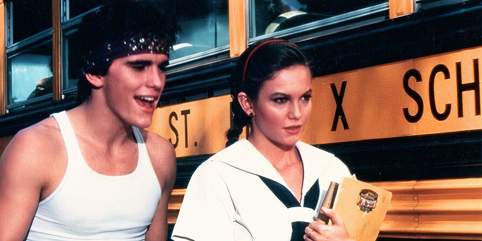 Matt Dillon standing next to Diane Lane near a school bus in Rumble Fish (1983)