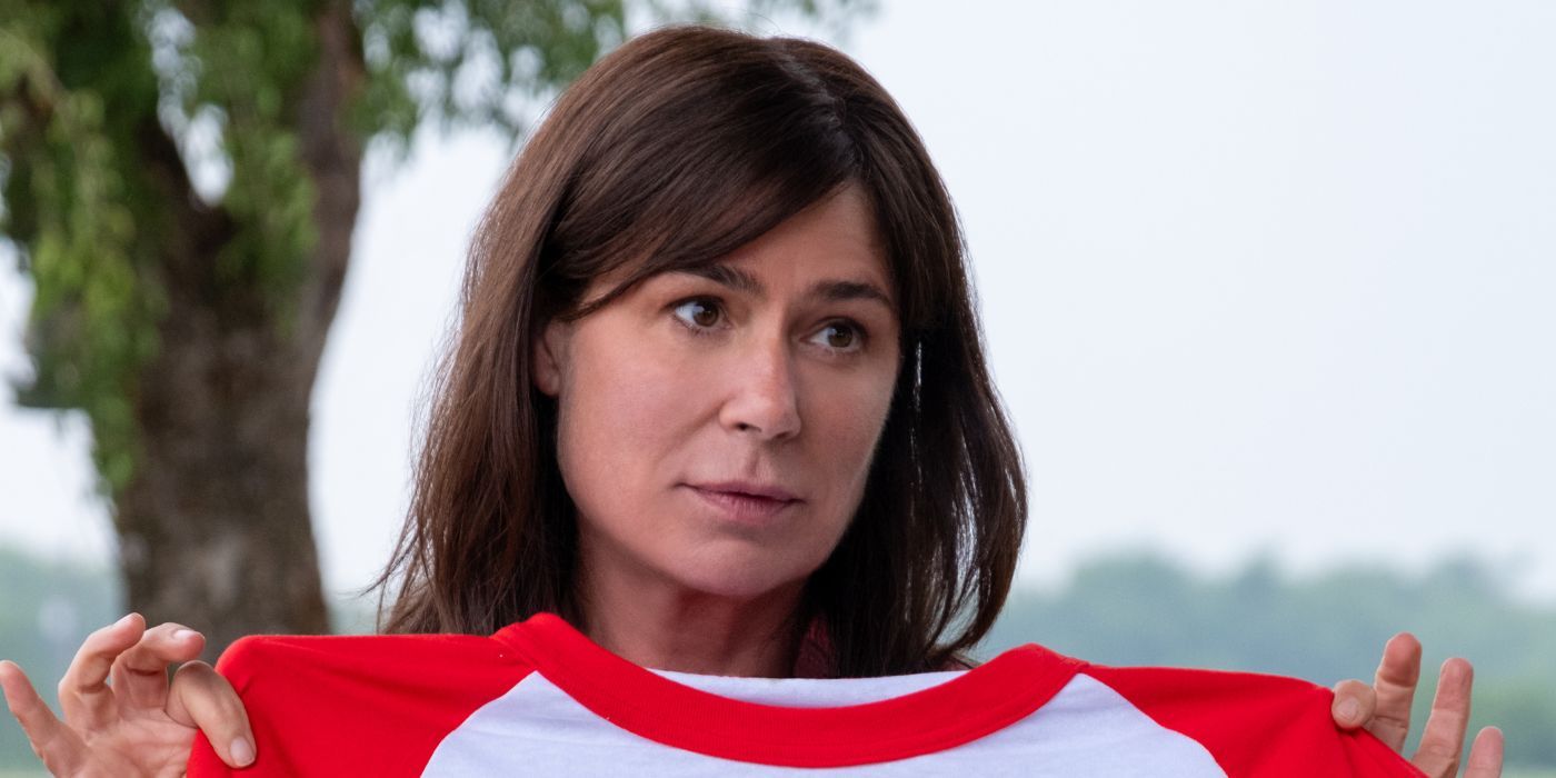 Maura Tierney holding up a red and white t-shirt as Cathy Cooper.