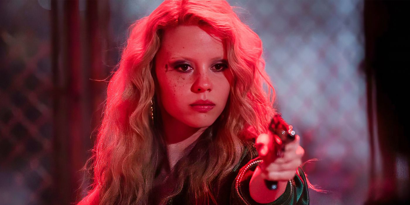 Mia Goth holding a gun under neon lighting with blonde hair in MaXXXine