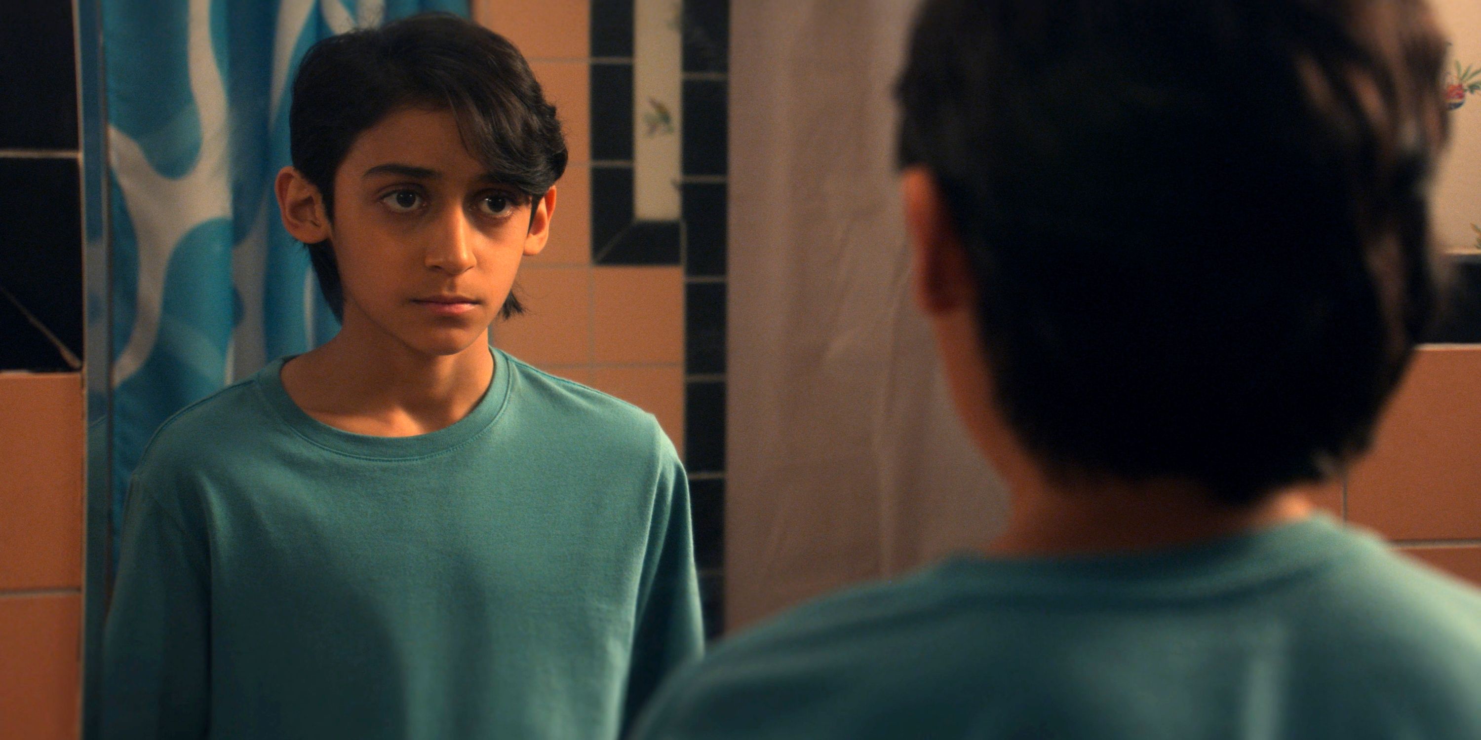 Lucian-River Chauhan as Ben looking in the mirror in the Apple TV+ series Me