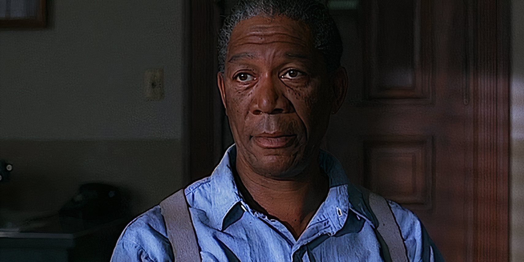 Red looking ahead with a monotone expression at his parole hearing in The Shawshank Redemption