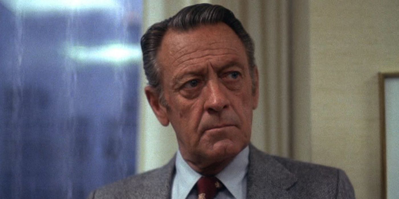 Max Schumacher looking to his left with a stern expression in Network