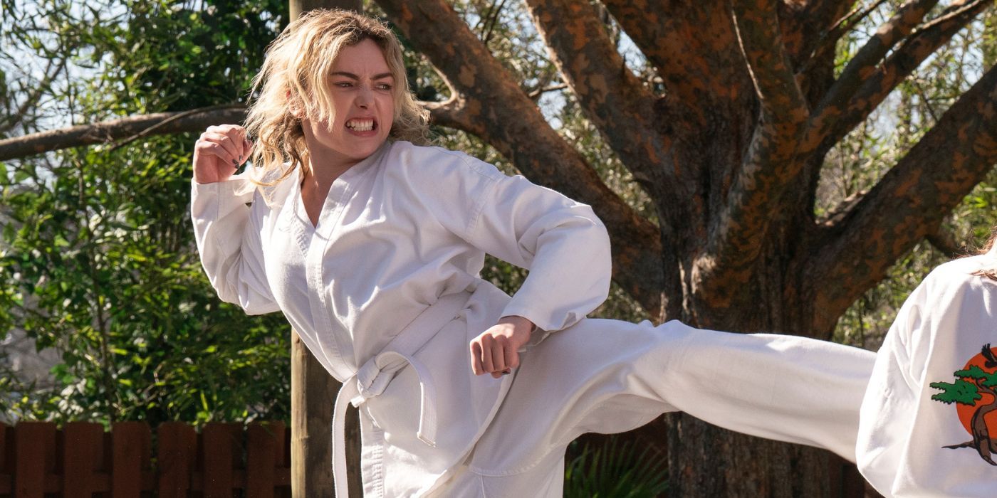 Peyton List as Tory, in a white gi and gritting her teeth while performing a karate kick in Cobra Kai