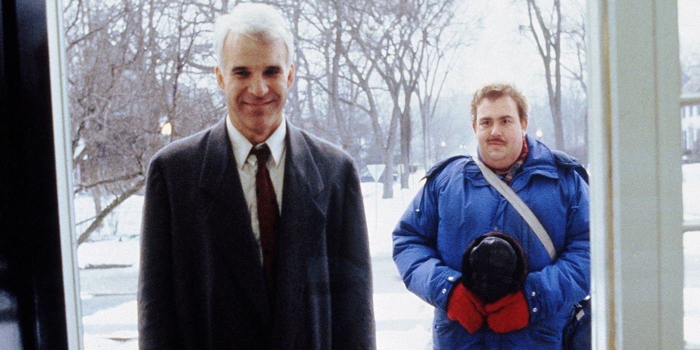 Steve Martin's Neil standing in the doorway with John Candy's Del in 