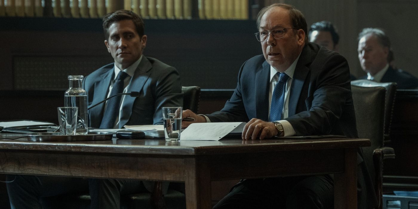 Rusty Sabich (Jake Gyllenhaal) and Raymond Horgan (Bill Camp) sit side-by-side at a desk in a scene from 'Presumed Innocent.'