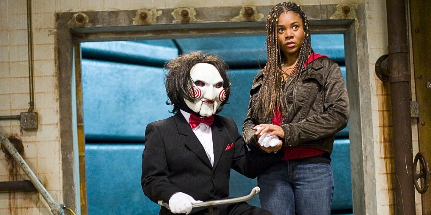 Regina Hall as Brenda Meeks holds the hand of a tricycle-riding Jigsaw from Saw in the movie Scary Movie 4