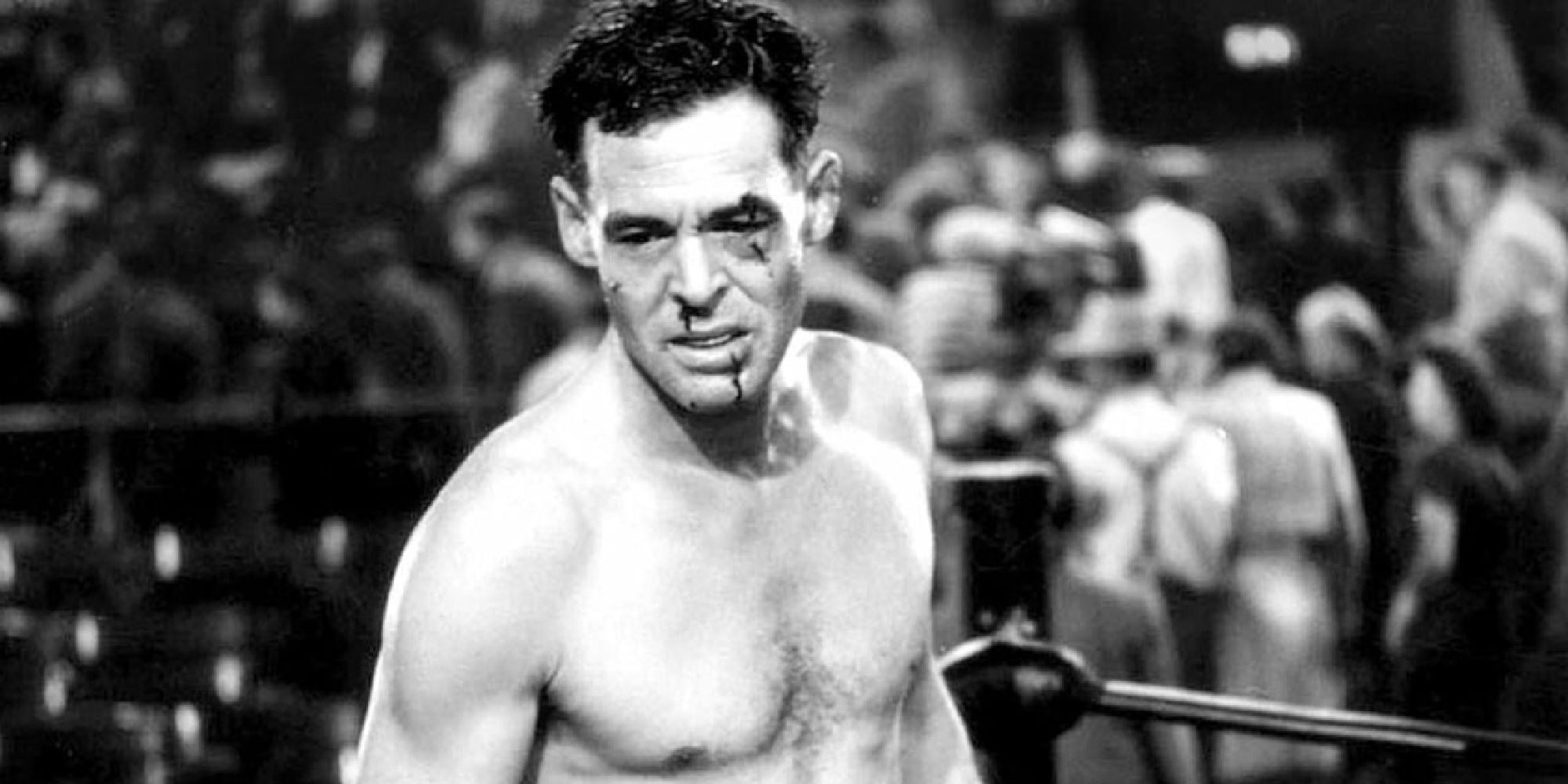 Robert Ryan as Bill with a bloody face inside a boxing ring in The Set-Up