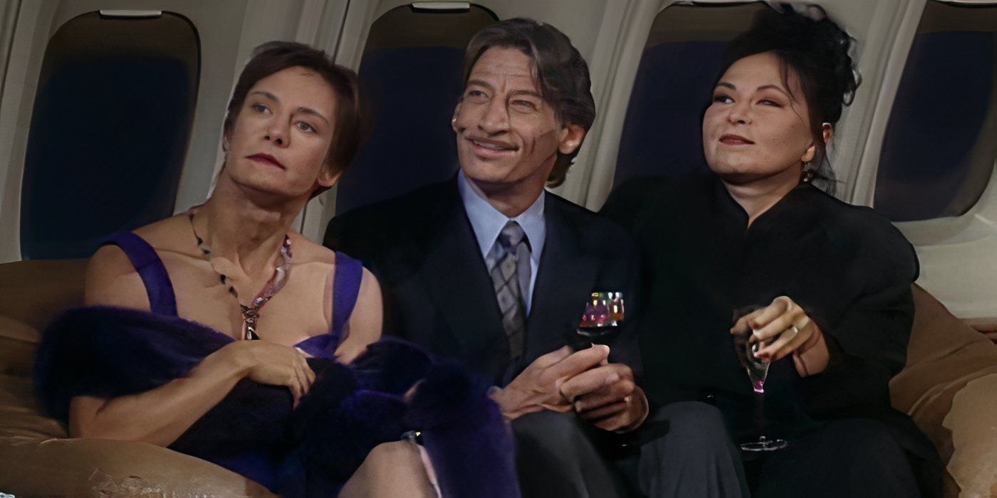 Jackie and Roseanne on a plane with a prince dressed to the nines in Roseanne.