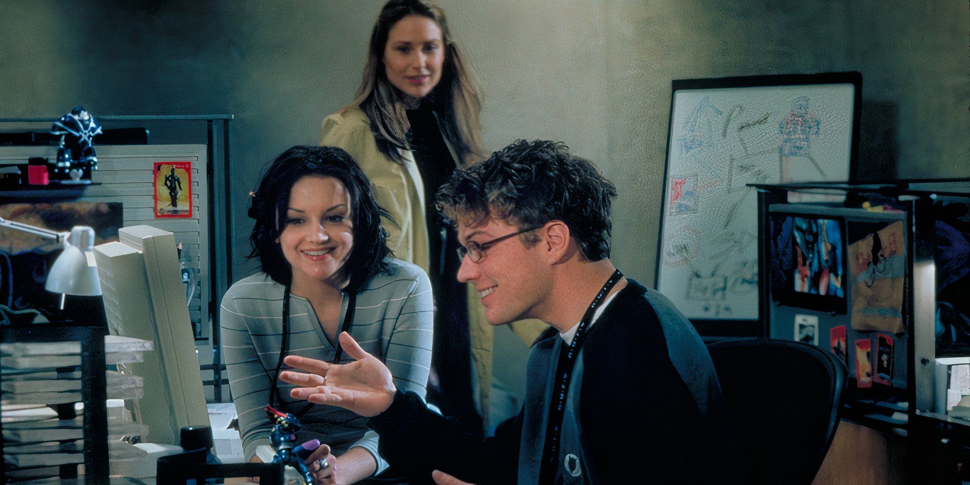 Milo (Ryan Phillippe) and Lisa (Rachel Leigh Cook) watch a computer screen smiling while Alice (Claire Forlani) looks on in the movie Antitrust