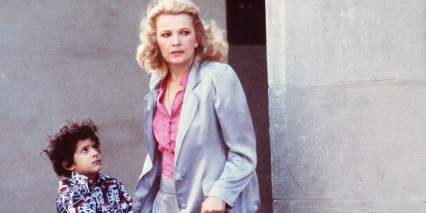 Gena Rowlands as Gloria and John Adames Phil in a grey suit standing at a street corner in 'Gloria'