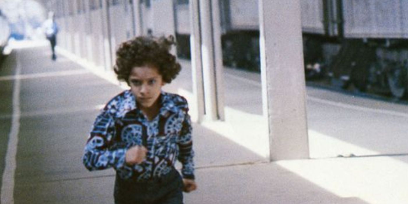John Adams as Phil in Gloria running down the train station platform in a blue shirt in &lsquo;Gloria&rsquo;