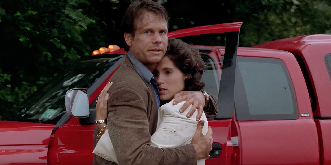 Bill Harding (Bill Paxton) hugs fiancée Dr. Melissa Reeves (Jami Gertz) by their truck in Twister (1996).