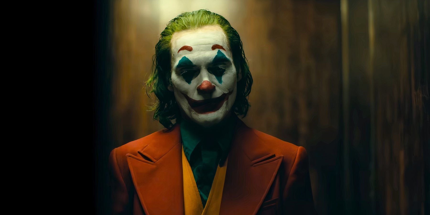 Joker, played by actor Jaoquin Phoenix, staring at the ground