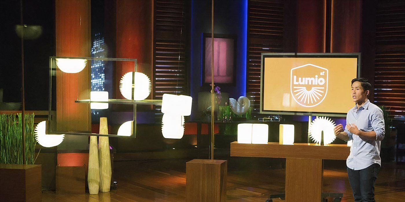 A man on Shark Tank pitching his company Lumio with lights around the room.