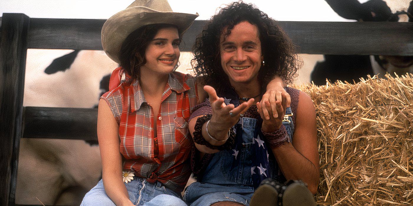 Carla Gugino and Pauly Shore dressed in country attire sitting in a stack of hay in Son in Law.