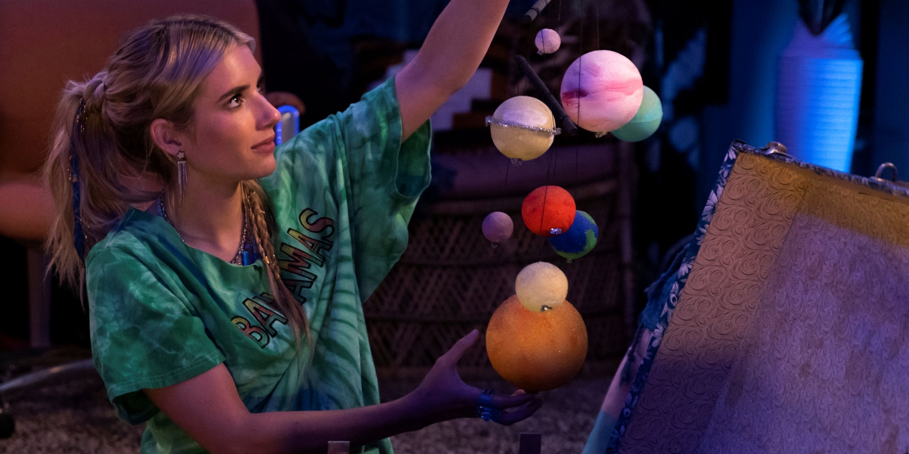 Emma Roberts as Rex holding up a mobile of planets in Space Cadet