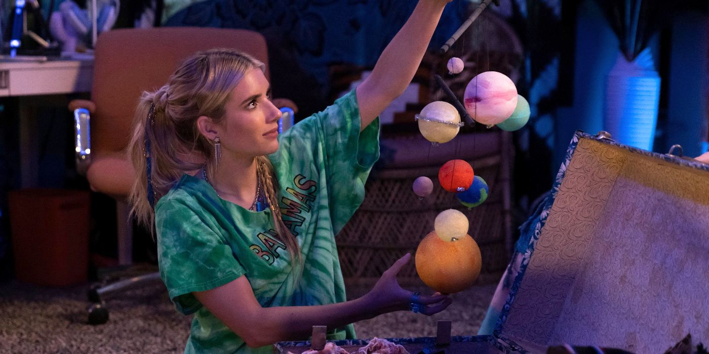 Emma Roberts as Rex Simpson, sitting on her floor and holding up a diorama of the solar system in Space Cadet