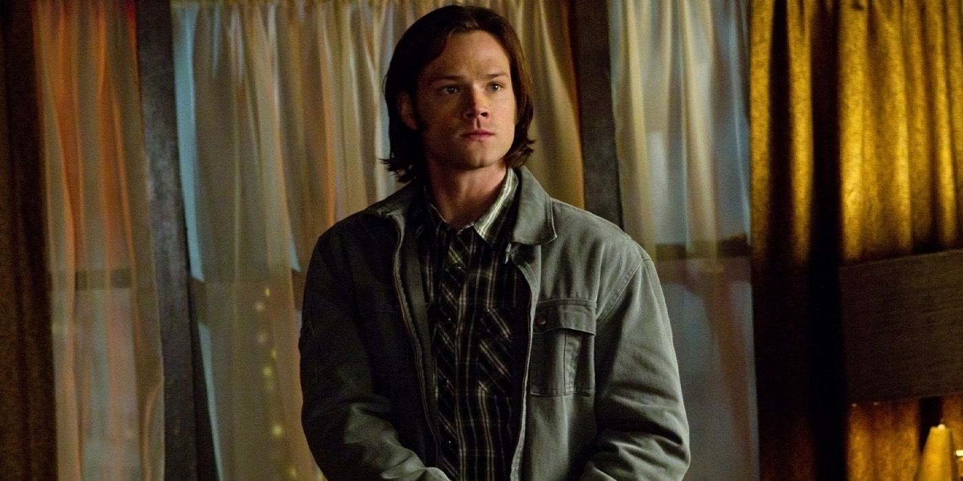 Jared Padalecki as Sam Winchester with a gun in a motel room in the 'Supernatural' episode "The Slice Girls."