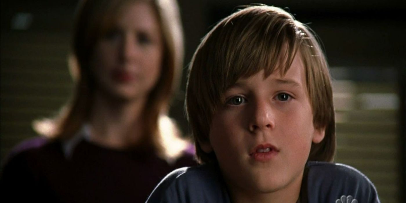 Jordan Garrett as Jake in SVU looking through a window with Casey Novak (Diane Neal) 