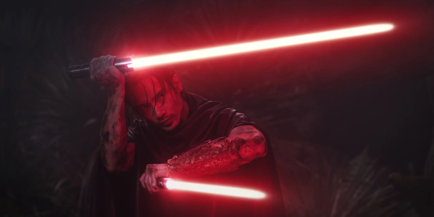 Qimir (Manny Jacinto) wielding dual red lightsabers, both pointing to the right with one held near his forehead and the other near his chest, in The Acolyte