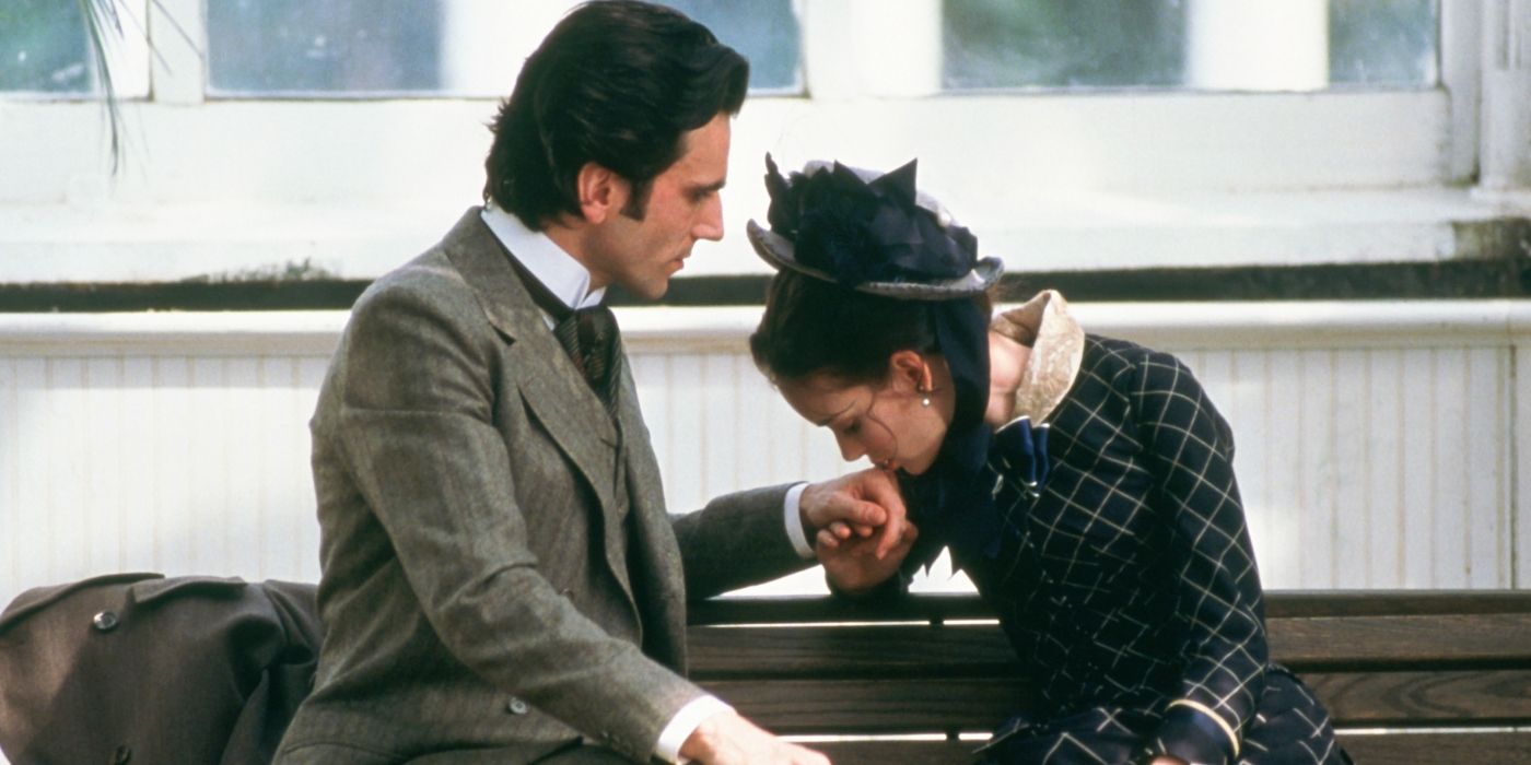 Mae, played by Winona Ryder, kisses the hand of Newland, played by Daniel Day-Lewis, in The Age of Innocence. 