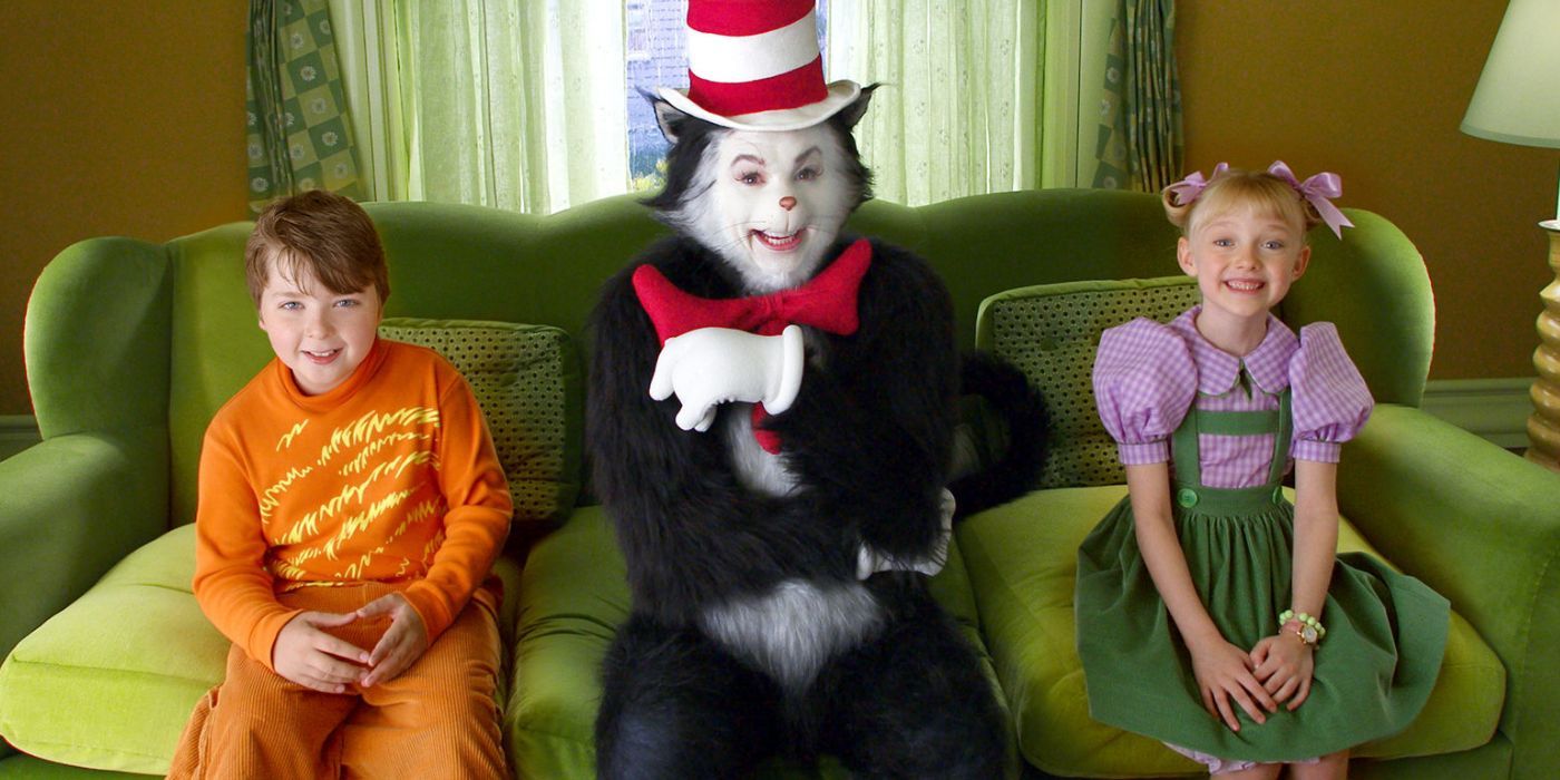 Two chidren sitting on a couch with the Cat in the Hat