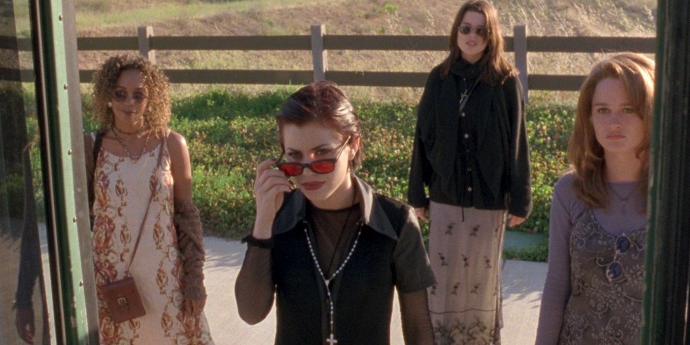 Rachel True, Fairuza Balk, Neve Campbell, and Robin Tunney standing outside a bus in The Craft (1996)