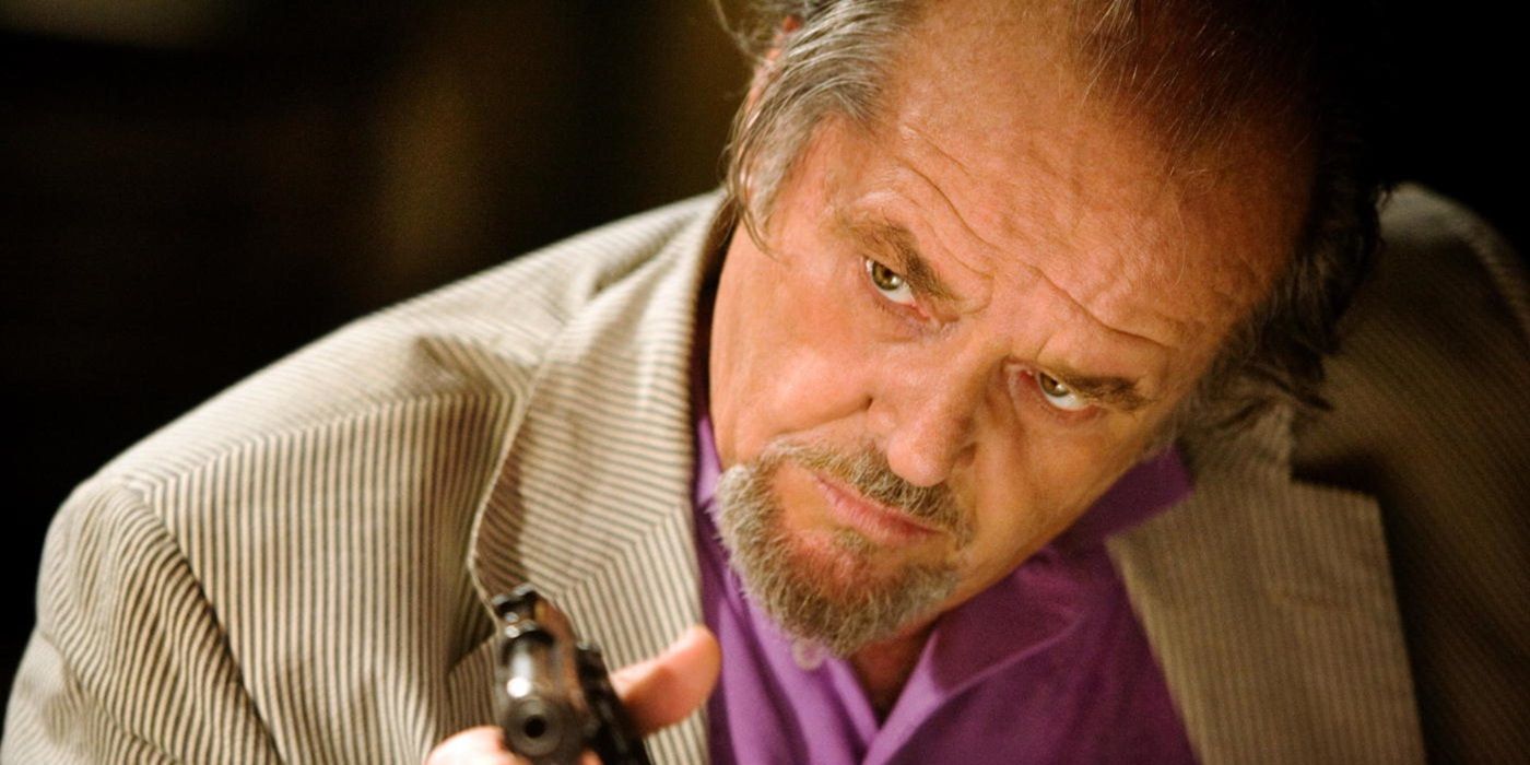 Jack Nicholson as Frank Costello pointing his gun at a person offscreen in The Departed