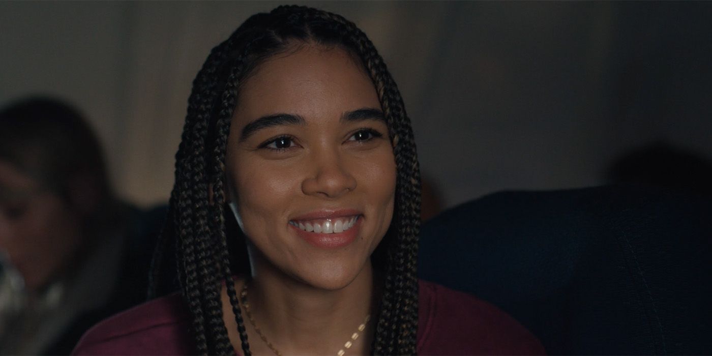 Alexandra Shipp smiling on a plane in The Good Half