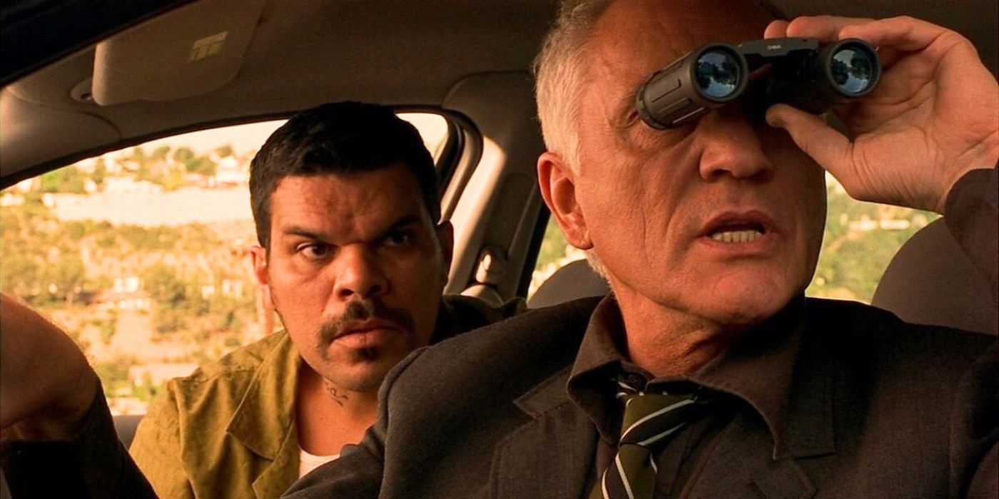Terence Stamp and Luis Guzmán spying on someone from their car in The Limey