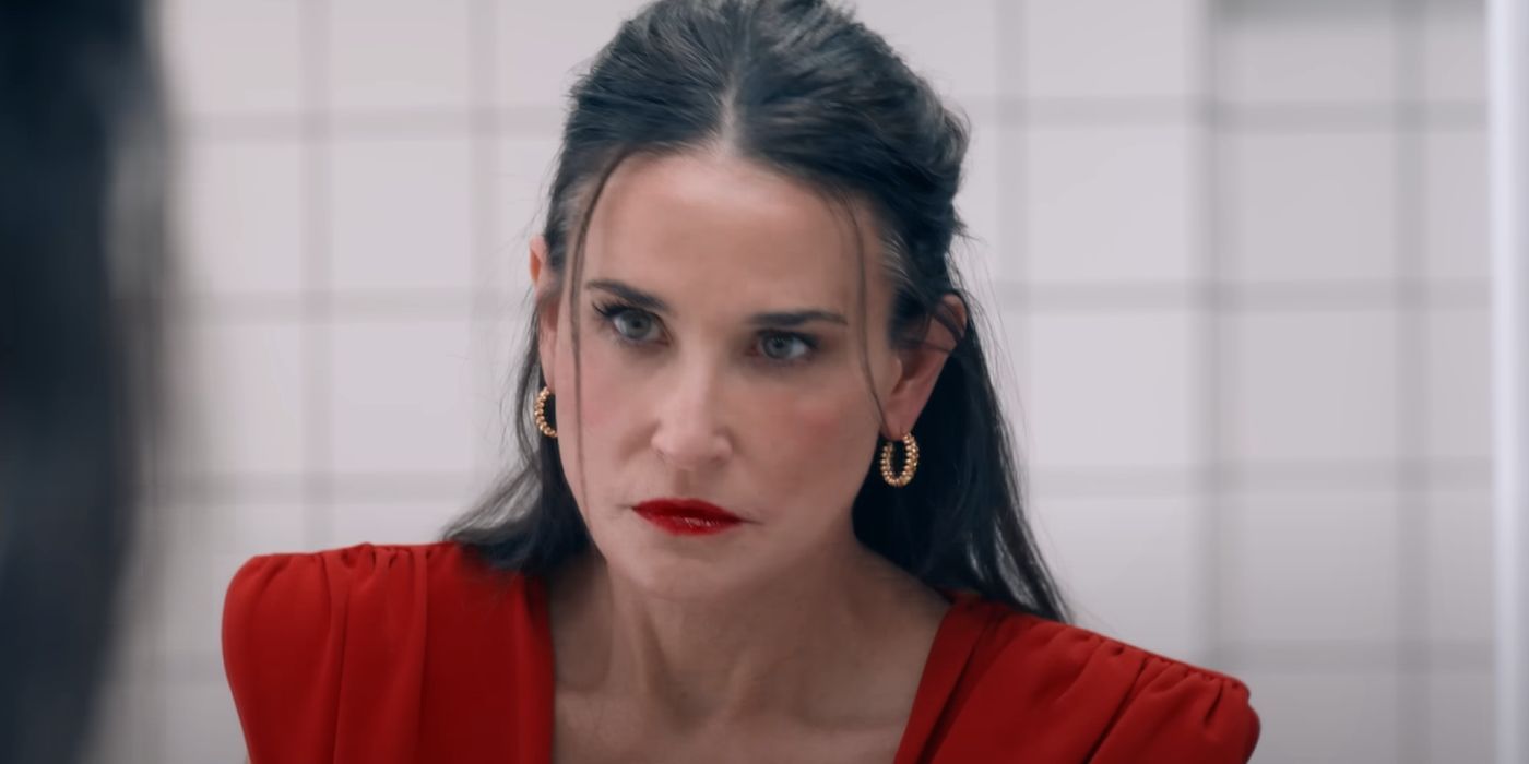 Demi Moore in a bathroom looking angry in a red dress.