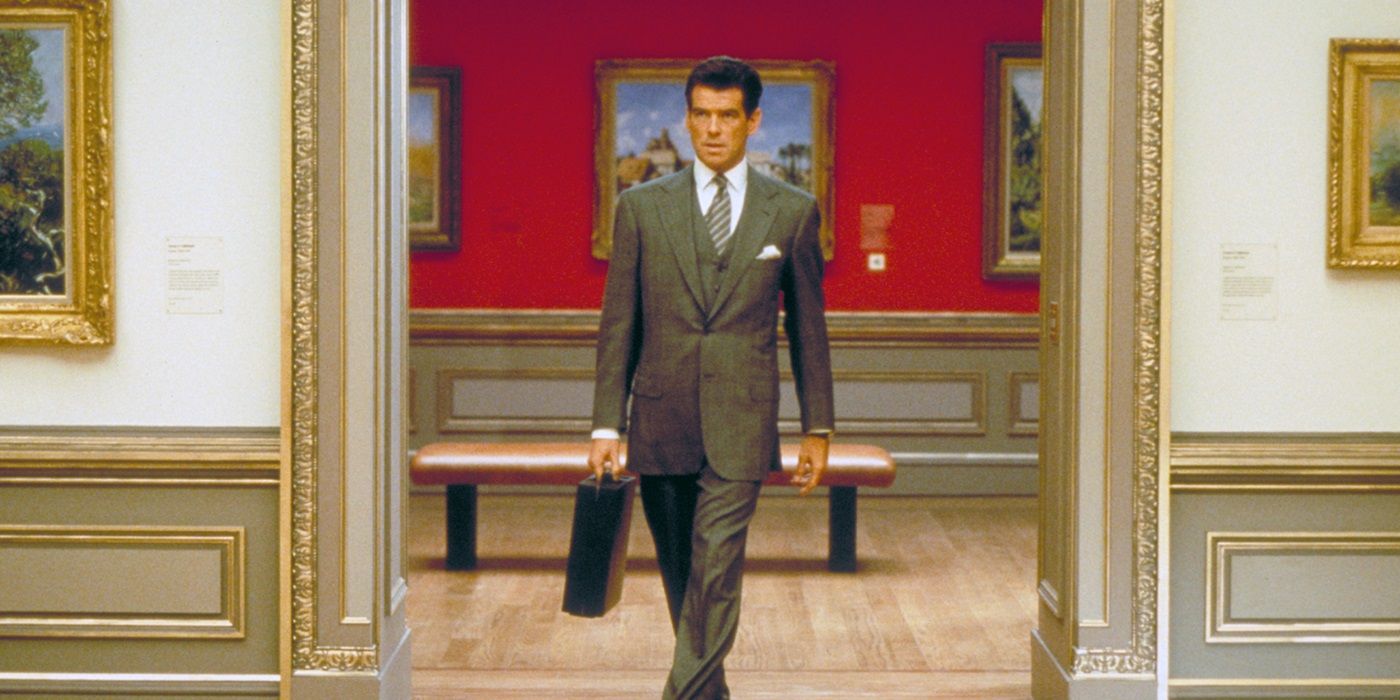 Pierce Brosnan as Thomas Crown walking confidently in an art gallery in The Thomas Crown Affair (1999)