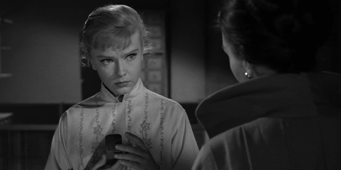 A woman holding a jewelry case and looking fearfully at another woman in the Twilight Zone episode The After Hours