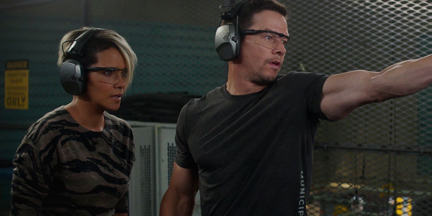 Halle Berry and Mark Wahlberg as Roxanne and Mike while Mike holds his arm outstretched in a training montage in The Union.