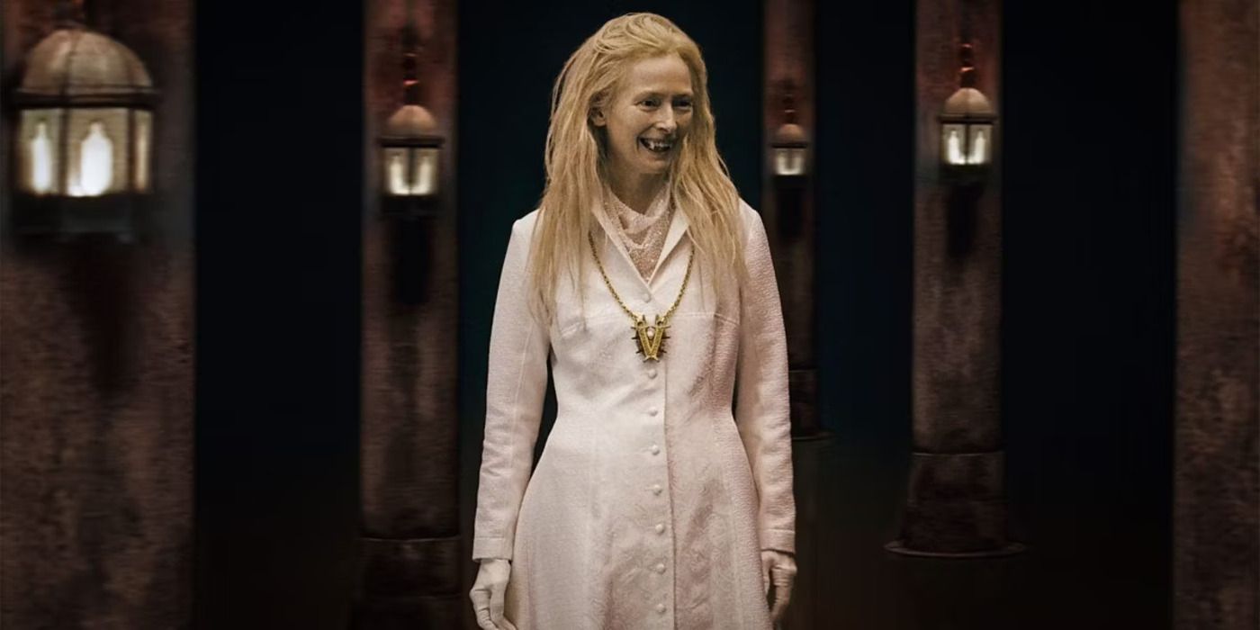 Tilda Swinton wears a white gown as part of the vampiric council in What We Do in the Shadows.