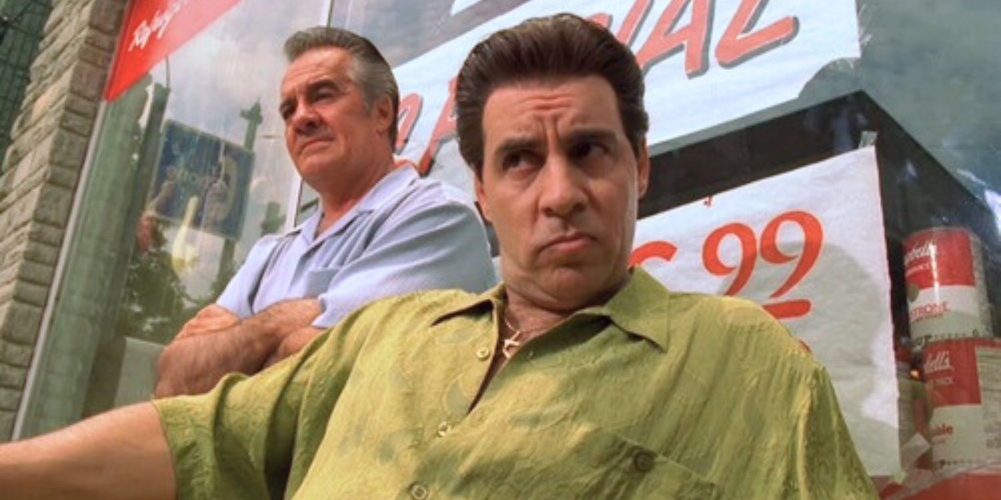 Tony Sirico as Paulie Walnuts with his arms crossed over his chest and standing behind Steven Van Zandt as Silvio Dante in The Sopranos