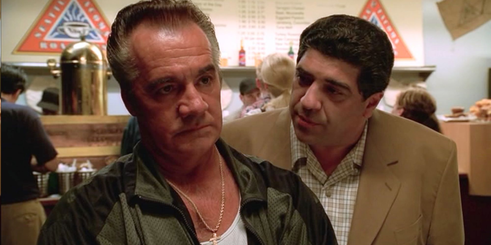 Tony Sirico looking straight ahead while Vincent Pastore is standing behind him in The Sopranos