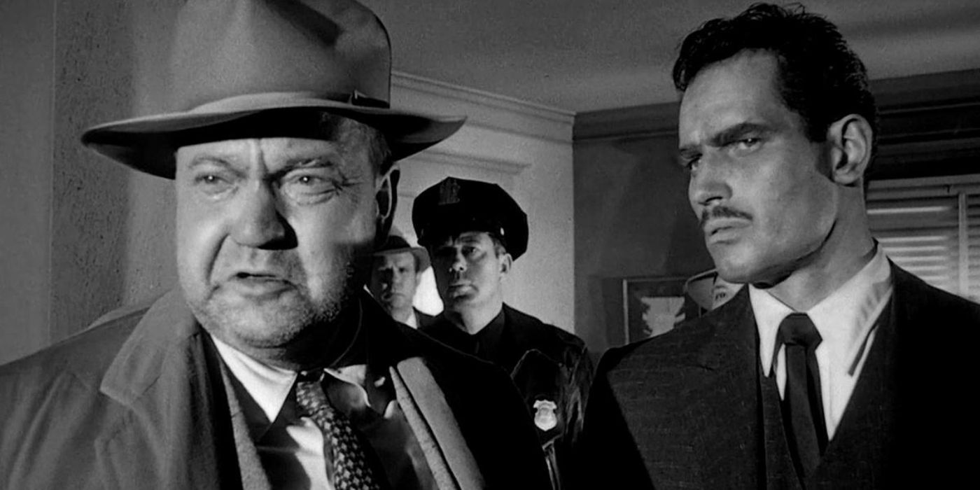 Grissled and corrupt police captain Hank Quinlan (Orson Welles) and Mexican prosecutor Ramon Miguel Vargas (Charlton Heston) stand alongside each other in a cramped room in 'Touch of Evil' (1958).