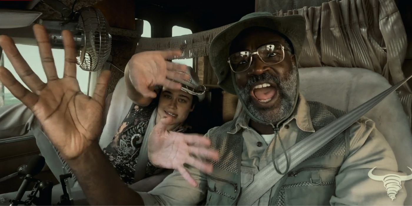 Tunde Adebimpe as Dexter waving his hand while driving a van in Twisters.