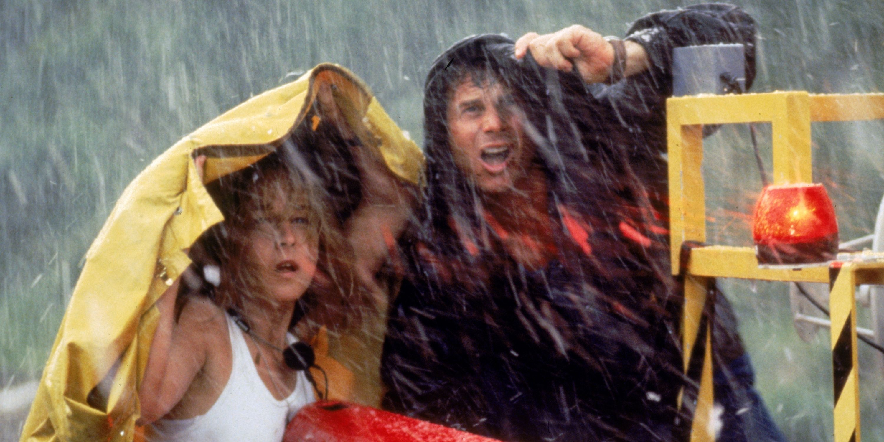 Helen Hunt as Jo and Bill Paxton as her husband Bill hiding under their coats during a storm in Twister