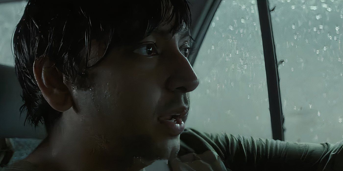 Nik Dodani as Praveen in a car while the rain pours outside in Twisters