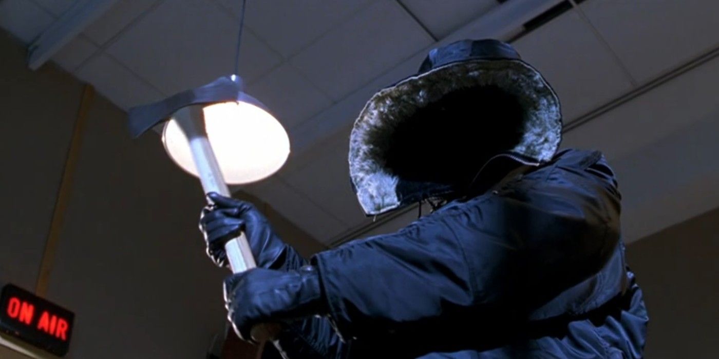 The killer in Urban Legend wearing a parka and swinging an axe