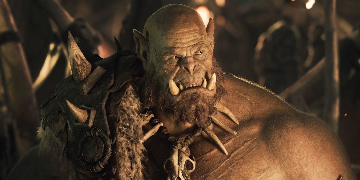 an orc warrior with large fangs protruding from his lower jaw, looks to the side in Warcraft