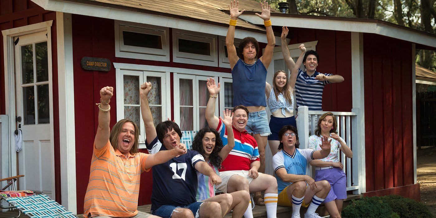 The cast of Wet Hot American Summer: First Day of Camp sitting on a stoop cheering.