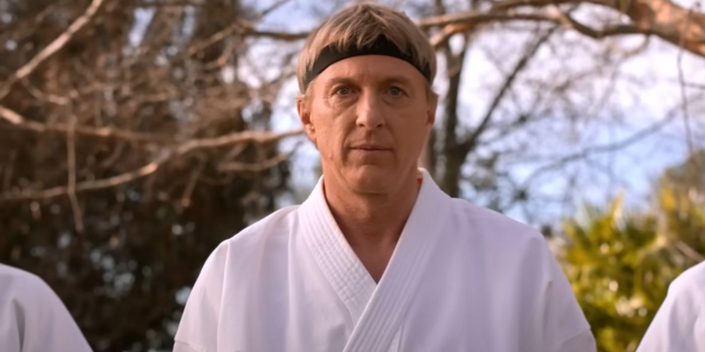 William Zabka as Johnny Lawrence in a white karate uniform facing forward in 