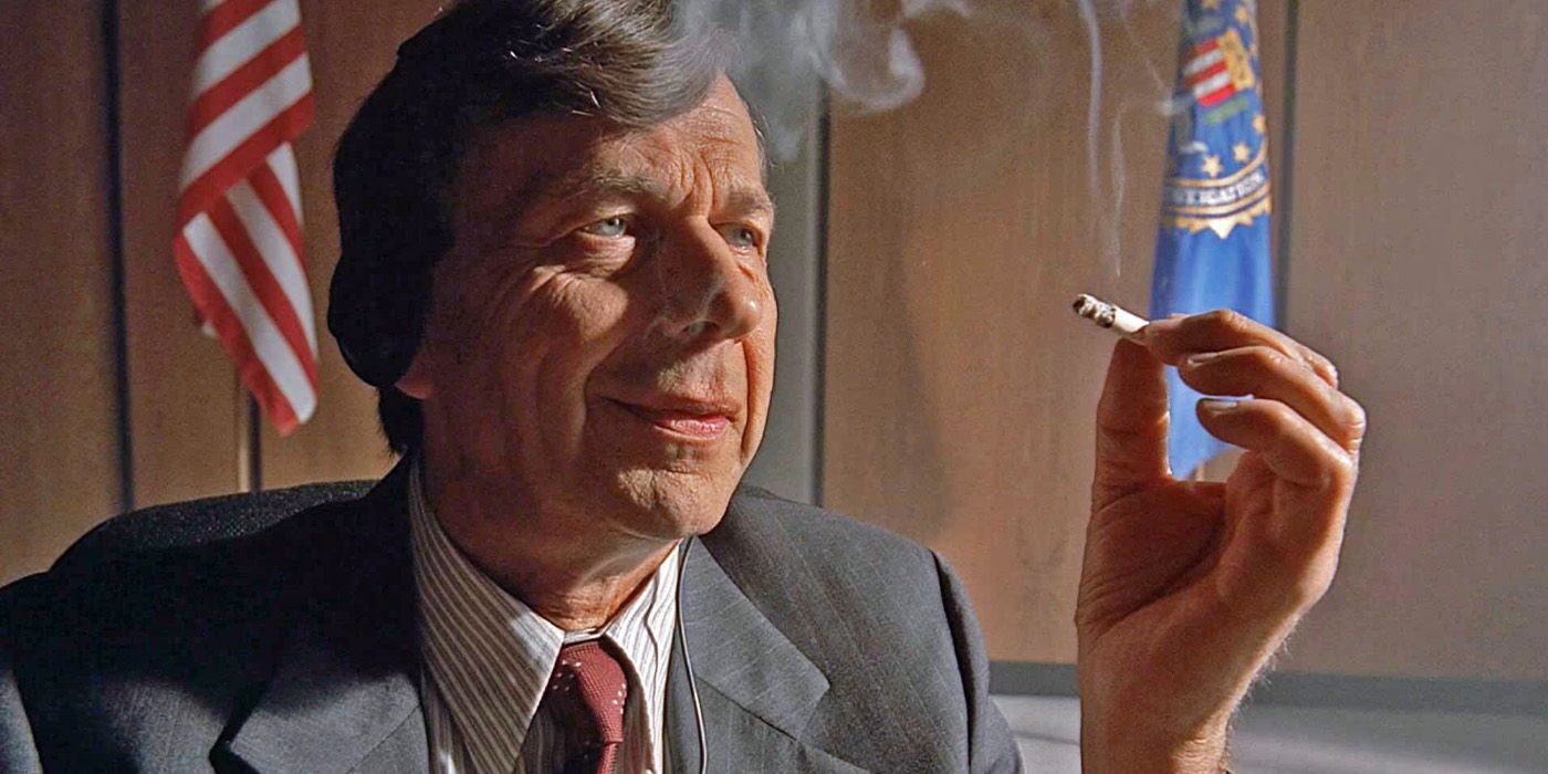 The Cigarette Smoking Man (William B. Davis) sits within his government office in 'The X-Files' episode "Musings of a Cigarette Smoking Man."