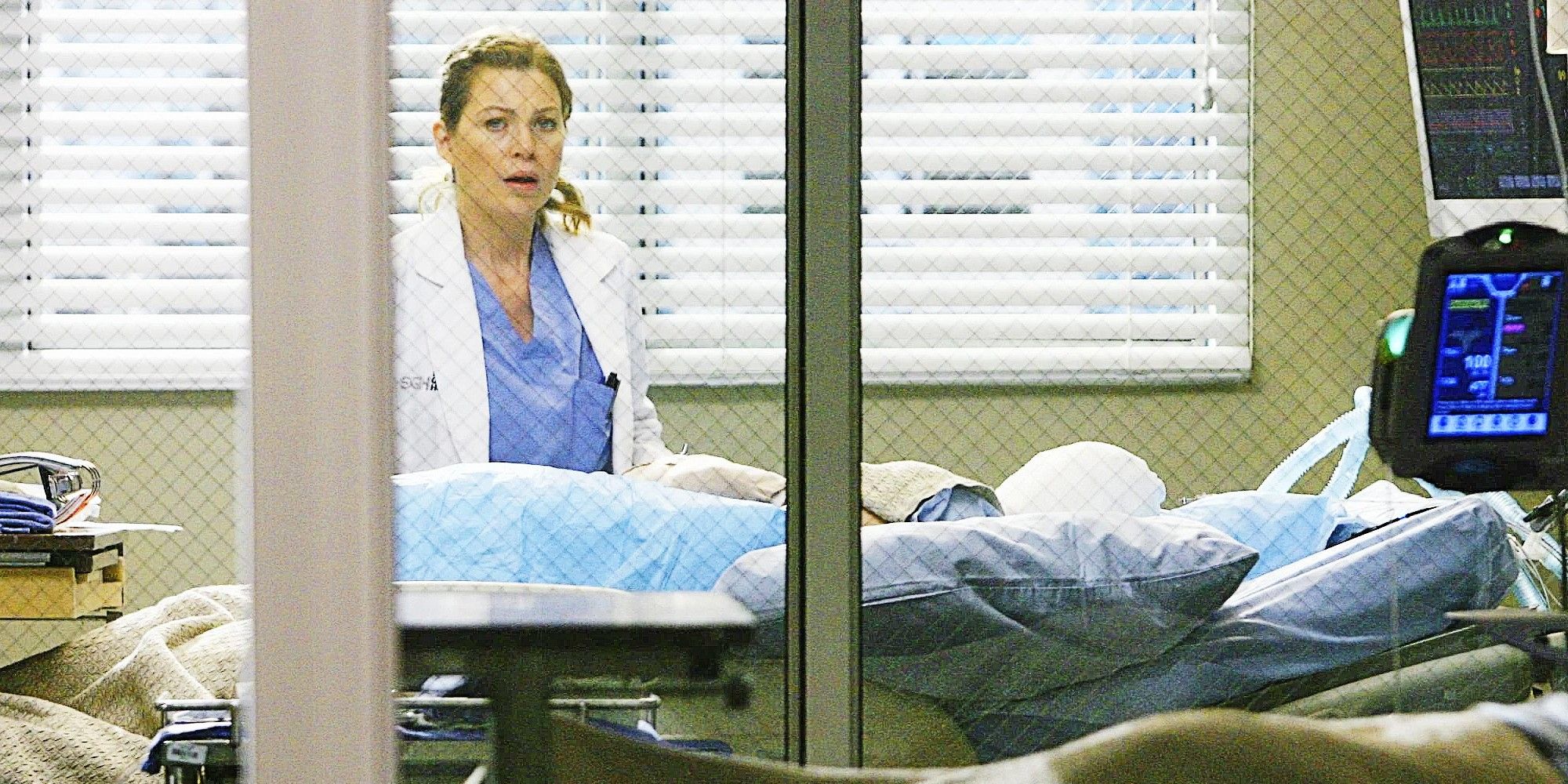 Meredith standing over George&rsquo;s hospital bed in Grey&rsquo;s Anatomy